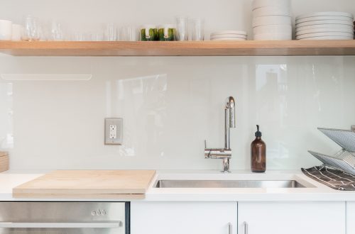white ceramic plates on white wooden kitchen cabinet