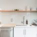 white ceramic plates on white wooden kitchen cabinet