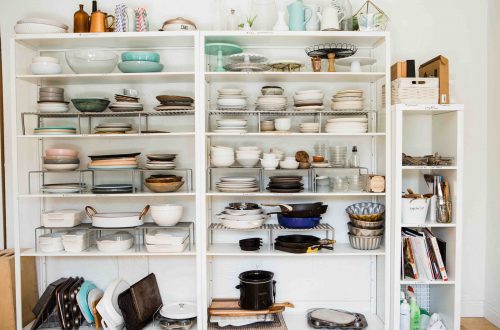 assorted ceramic dinnerware set displayed in white wooden shelf