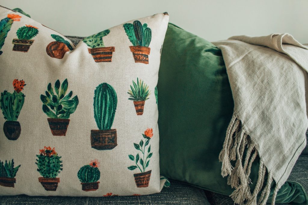 cactus-printed throw pillows on chair