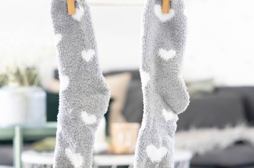 white and gray socks on brown wooden clothes hanger