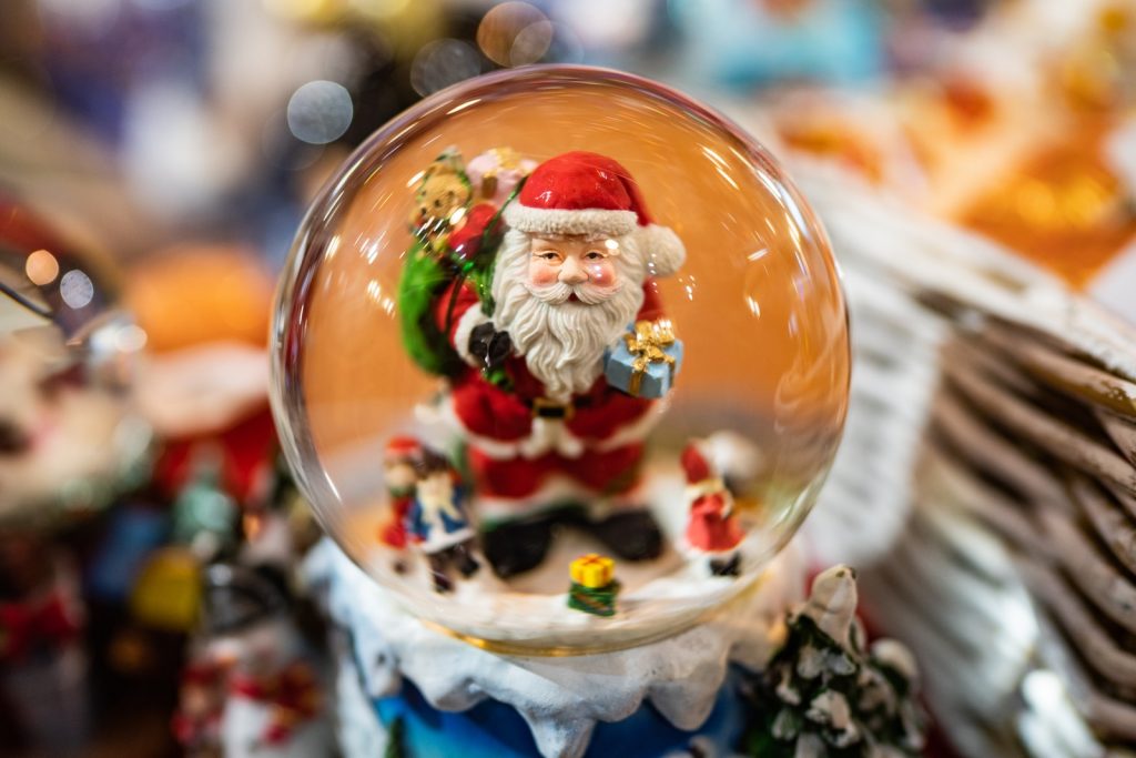 selective focus photography of Santa Claus snowglove