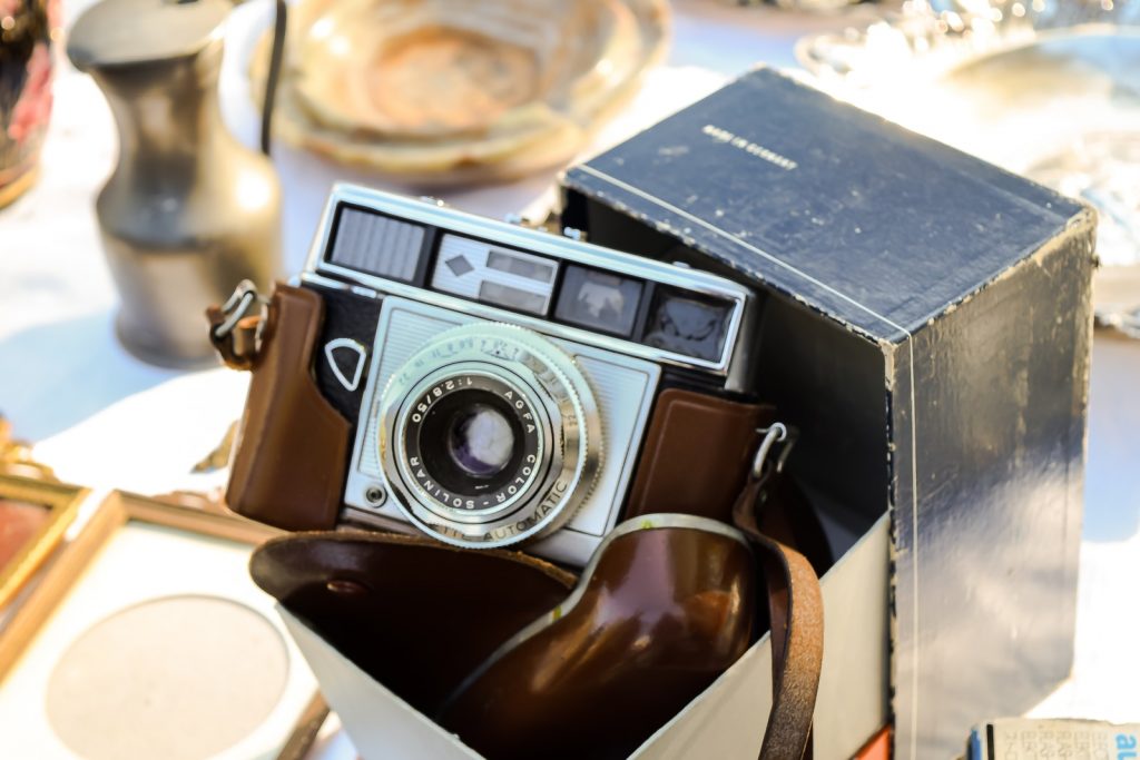 black and silver vintage camera on brown wooden table